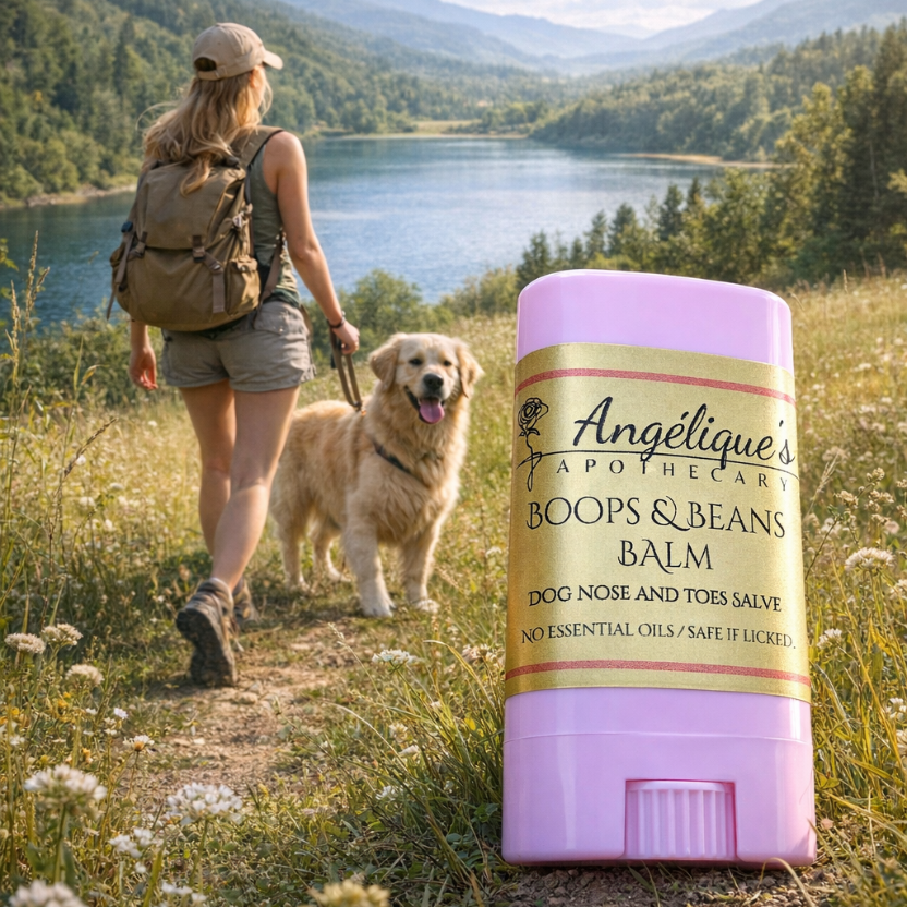 Woman hiking with a dog and Angélique's Apothecary Boops & Beans Balm in the foreground.