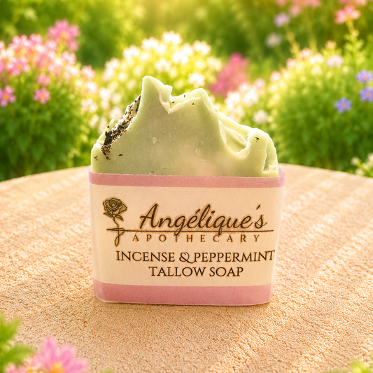 Bar of soap with 'Angélique's Apothecary' branding against a natural background with flowers.