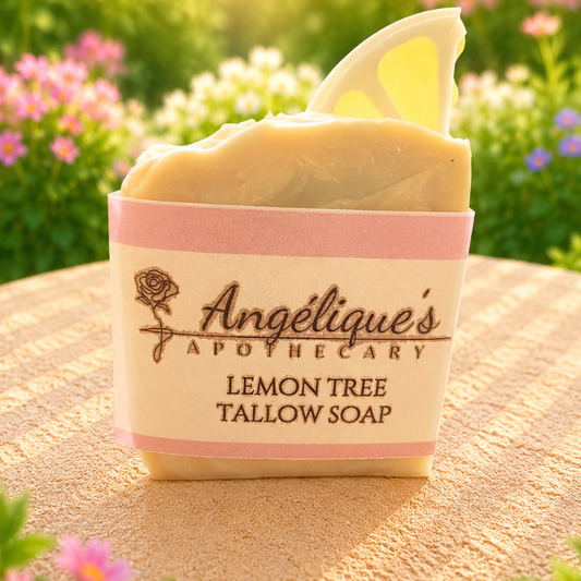 Bar of soap with 'Angéliques Apothecary' branding on a wooden surface with flowers in the background